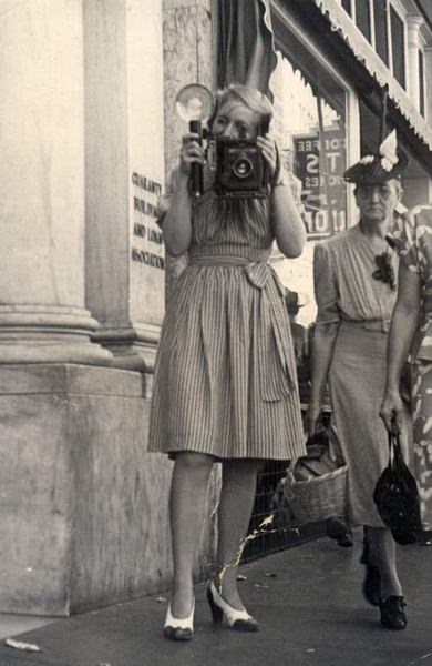 #112 Shirlie Montgomery with camera, 1950
