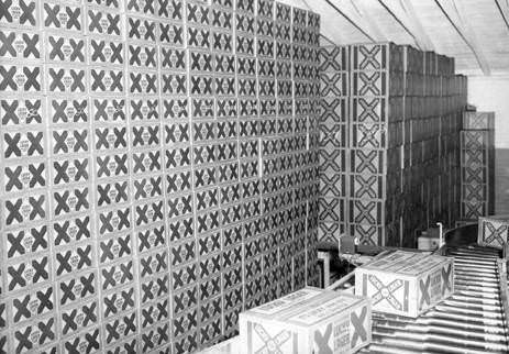 #14 Boxes of Lucky Lager beer sit next to a production line at the Lucky Lager Brewery in Vancouver, 1953