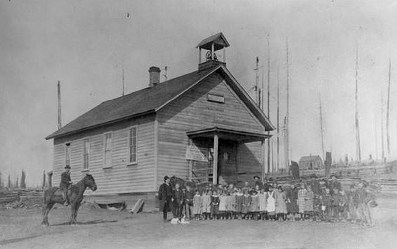 #5 The children and a man on a horse stand in front of Eureka School House in Hockinson, 1889