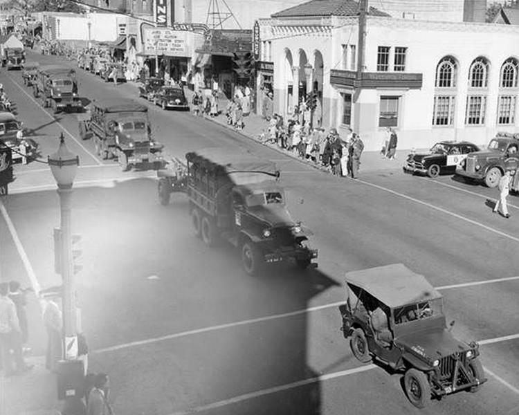 #28 A line of military vehicles move down the street during the Cenaqua Parade on August 6, 1950 in Vancouver, Washington.