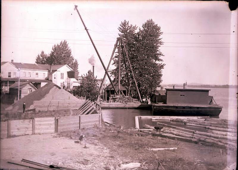 #39 Dock scene on Vancouver’s Waterfront with the Alta House in the background, 1880