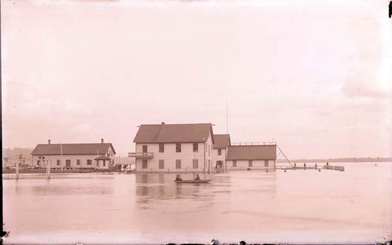 #31 Two people in a boat travel through a flooded area of Vancouver, 1893
