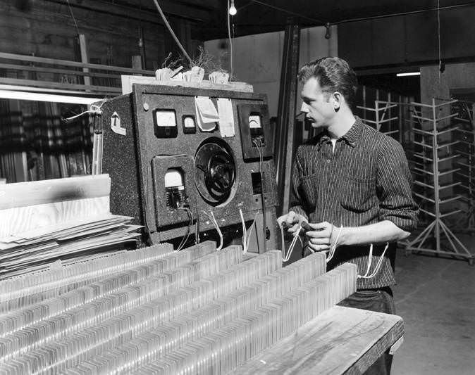 #48 A worker checks for elements at the Electro Ray Manufacturing Company in Vancouver, 1961