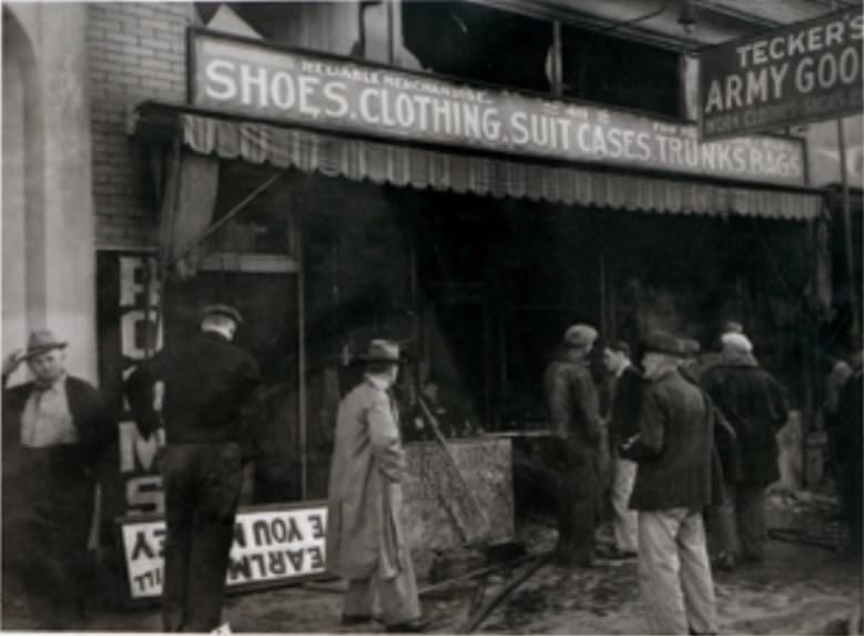 #29 People inspect the damage caused by a fire at a army goods store in Vancouver, Washington, 1940