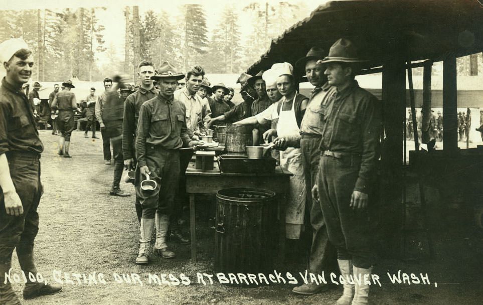 #33 Soldiers stand in line or hover in the background to receive their meal, 1918