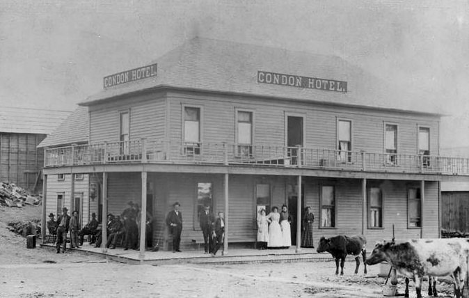 #17 The exterior of the Condon Hotel in Vancouver, Washington with people and livestock outside the hotel, 1880s