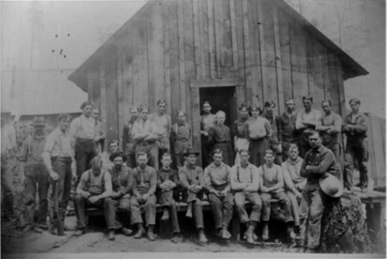 #30 Railroad workers sitting on the North Abutment during the construction of the Vancouver Railroad Bridge, 1907