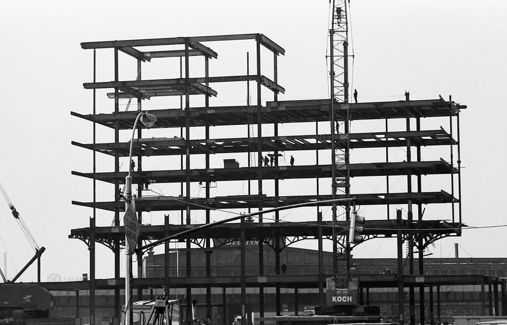 #28 Silhouettes of construction workers can be seen on I beams, as Tower Two of the World Trade Center is erected in the winter of 1970