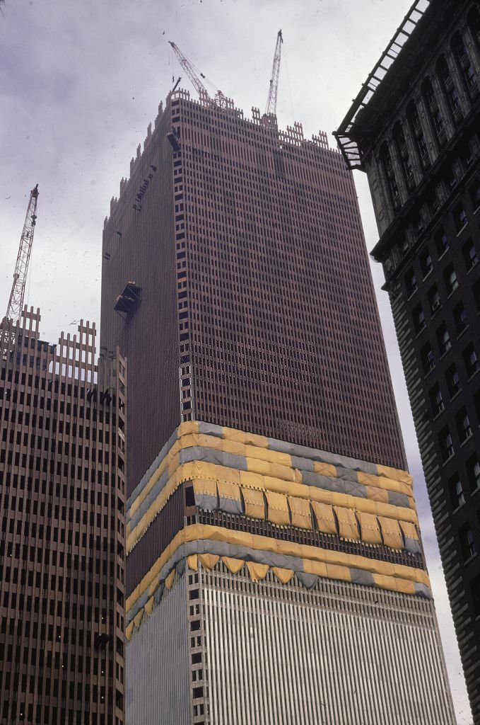 #37 Low-angle view of cranes atop one tower of the World Trade Center during its construction, 1970.