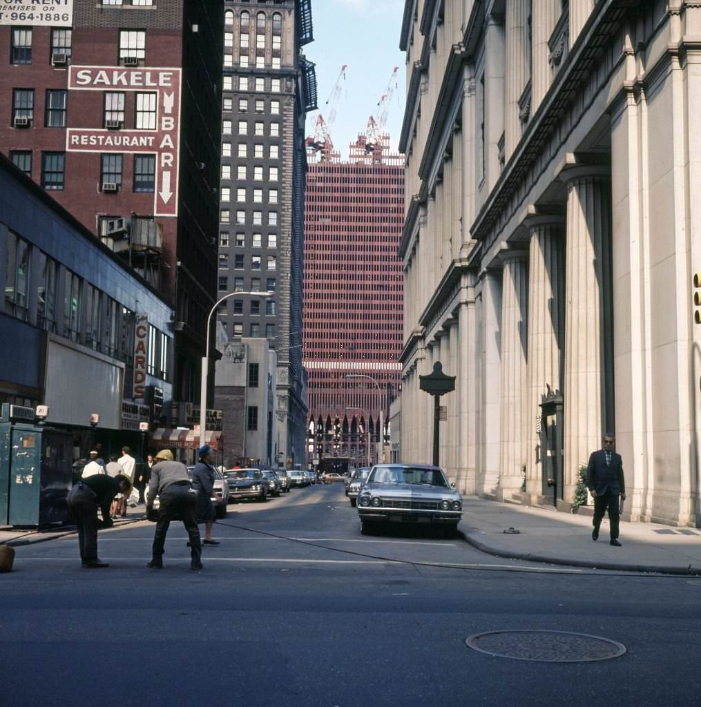 #45 Looking west, along Dey Street (at Broadway) of the on-going construction of One World Trade Center (North Tower), 1969