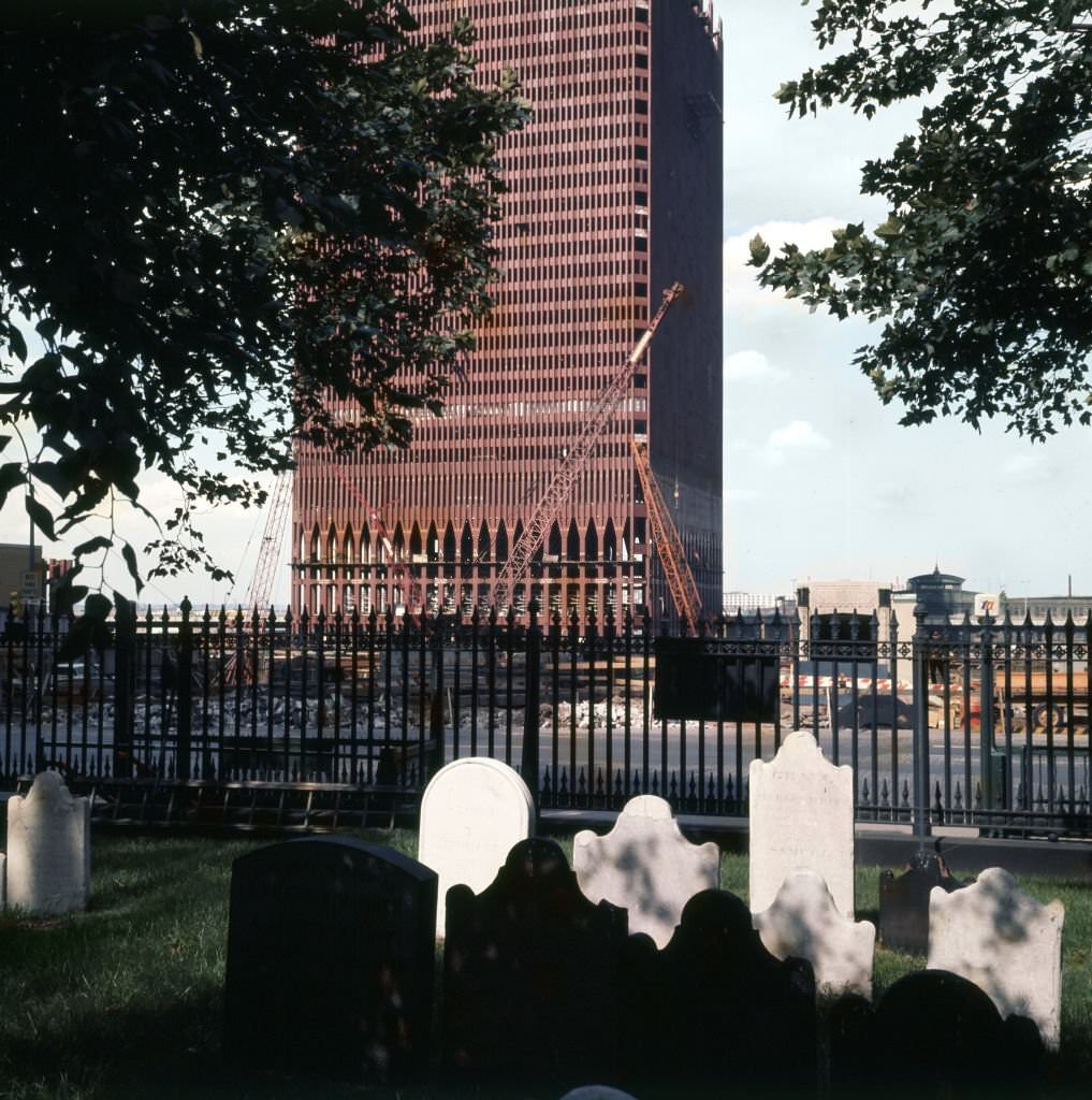 #46 Looking west across grave stones outside St Paul’s Chapel (at Church and Fulton streets), of the construction of One World Trade Center (North Tower), 1969