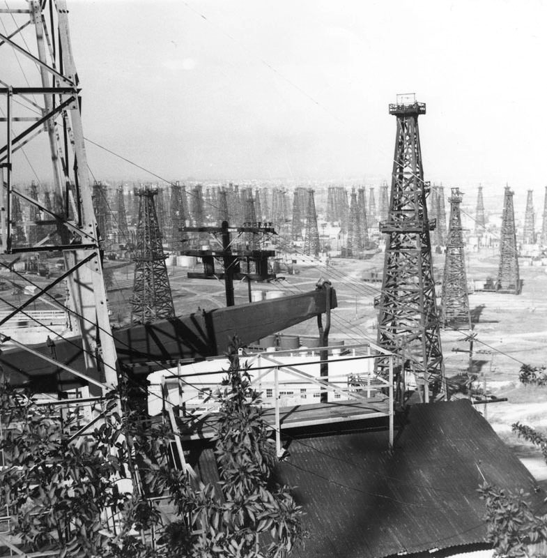 #78 An oil field covered with derricks in an unidentified area of Los Angeles.