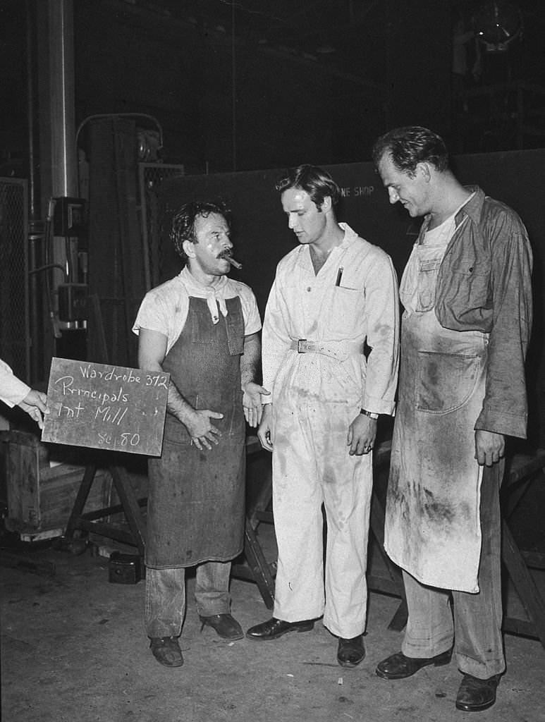 #25 Greek actor Nick Dennis talks with Marlon Brando and Karl Malden during a wardrobe test for the film, ‘A Streetcar Named Desire,.