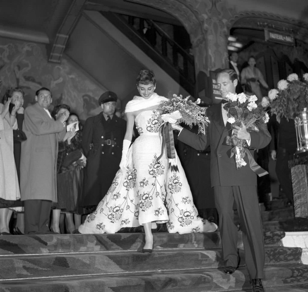 #37 Audrey Hepburn accompanied by her husband actor Mel Ferrer, in Amsterdam.