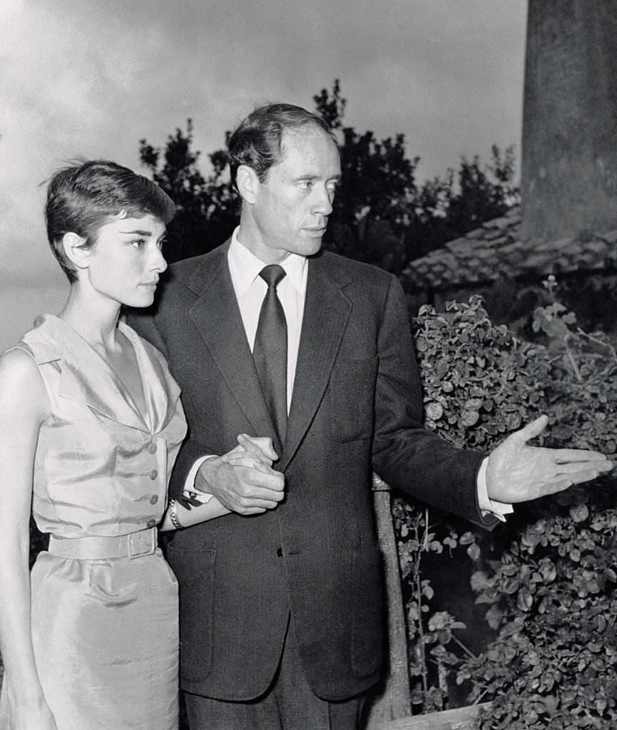 #41 Audrey Hepburn and Mel Ferrer Holding Hands at their Honeymoon Abode.