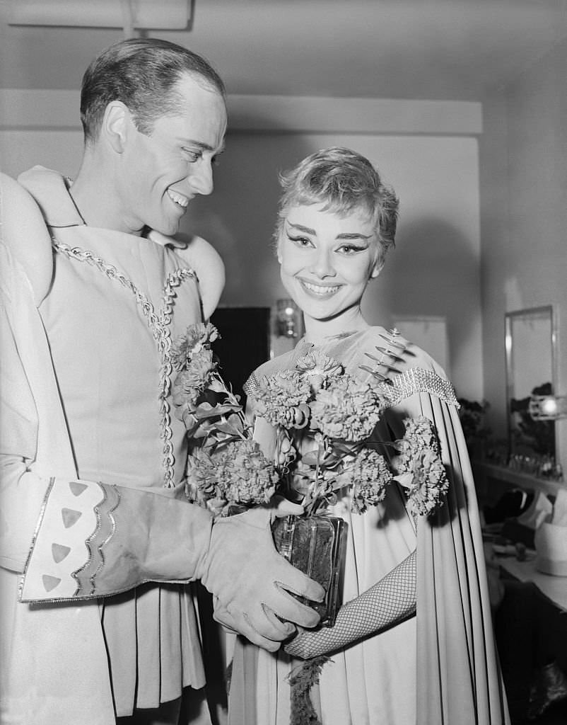 #42 Audrey Hepburn is shown with a bouquet of flowers, after the premiere of “Ondine” at the 46th Street Theater.
