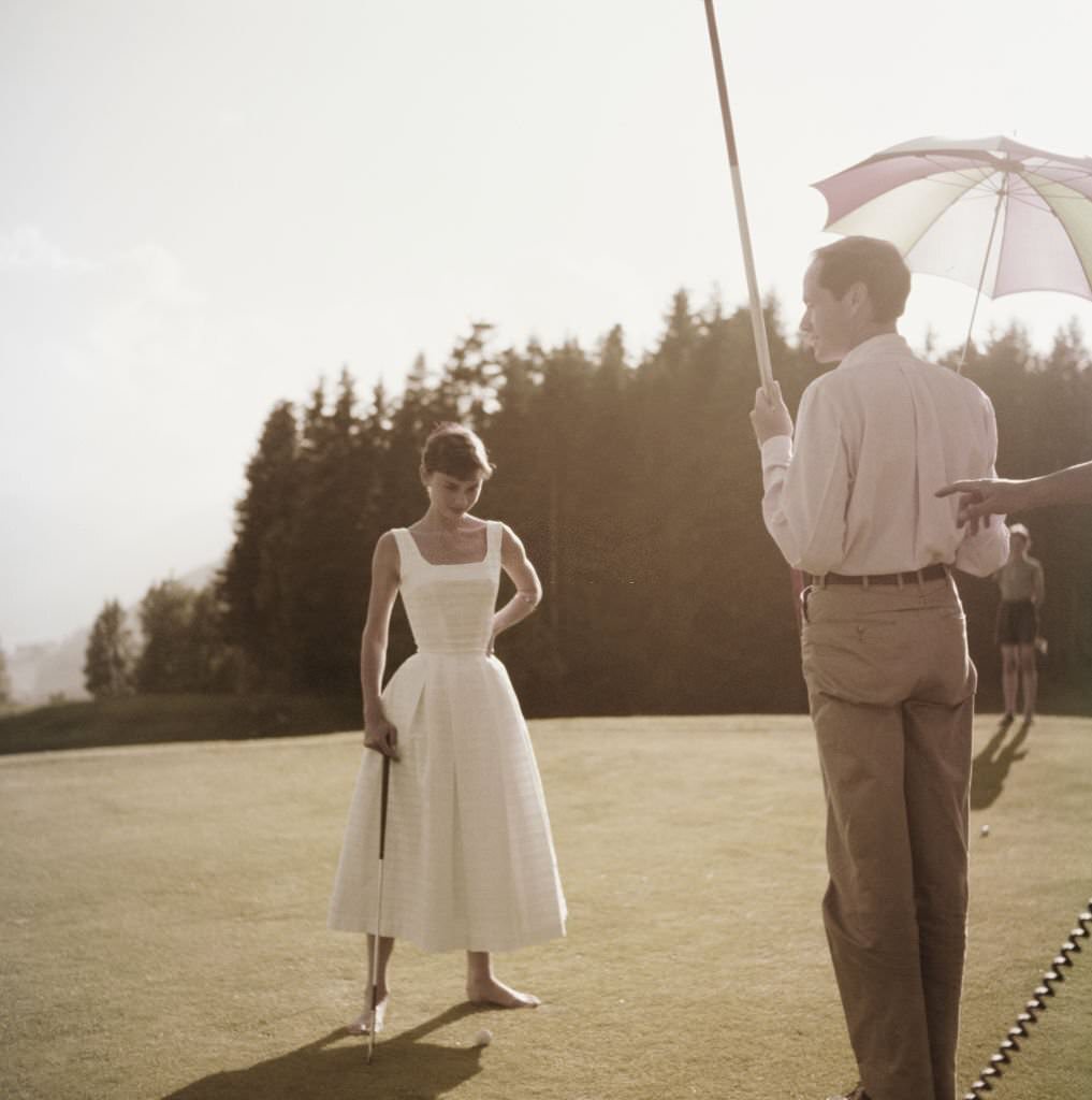 #48 Audrey Hepburn and Mel Ferrer on a golf course at the Bürgenstock resort, Switzerland, 1954.