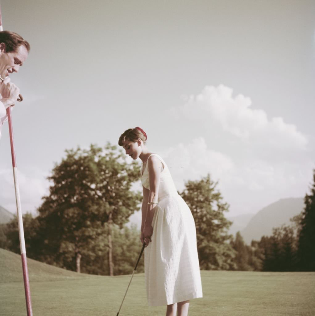 #51 Audrey Hepburn and Mel Ferrer on a golf course at the Bürgenstock resort, Switzerland, 1954.