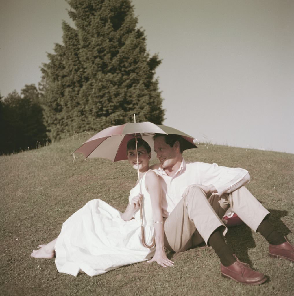 #52 Audrey Hepburn and Mel Ferrer on a golf course at the Bürgenstock resort, Switzerland, 1954.