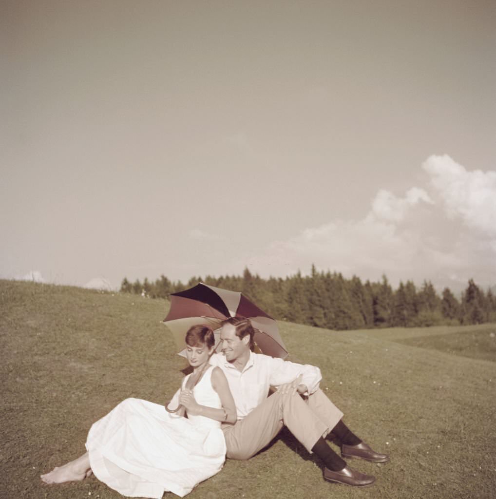 #58 Audrey Hepburn with her husband Mel Ferrer on a golf course at the Bürgenstock resort, Switzerland, 1954.