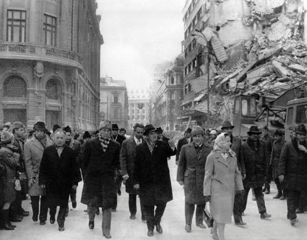 #89 Romanian president Nicolae Ceausescu observing the damages on the Gheorghe Magheru Boulevard in Bucharest after an earthquake.