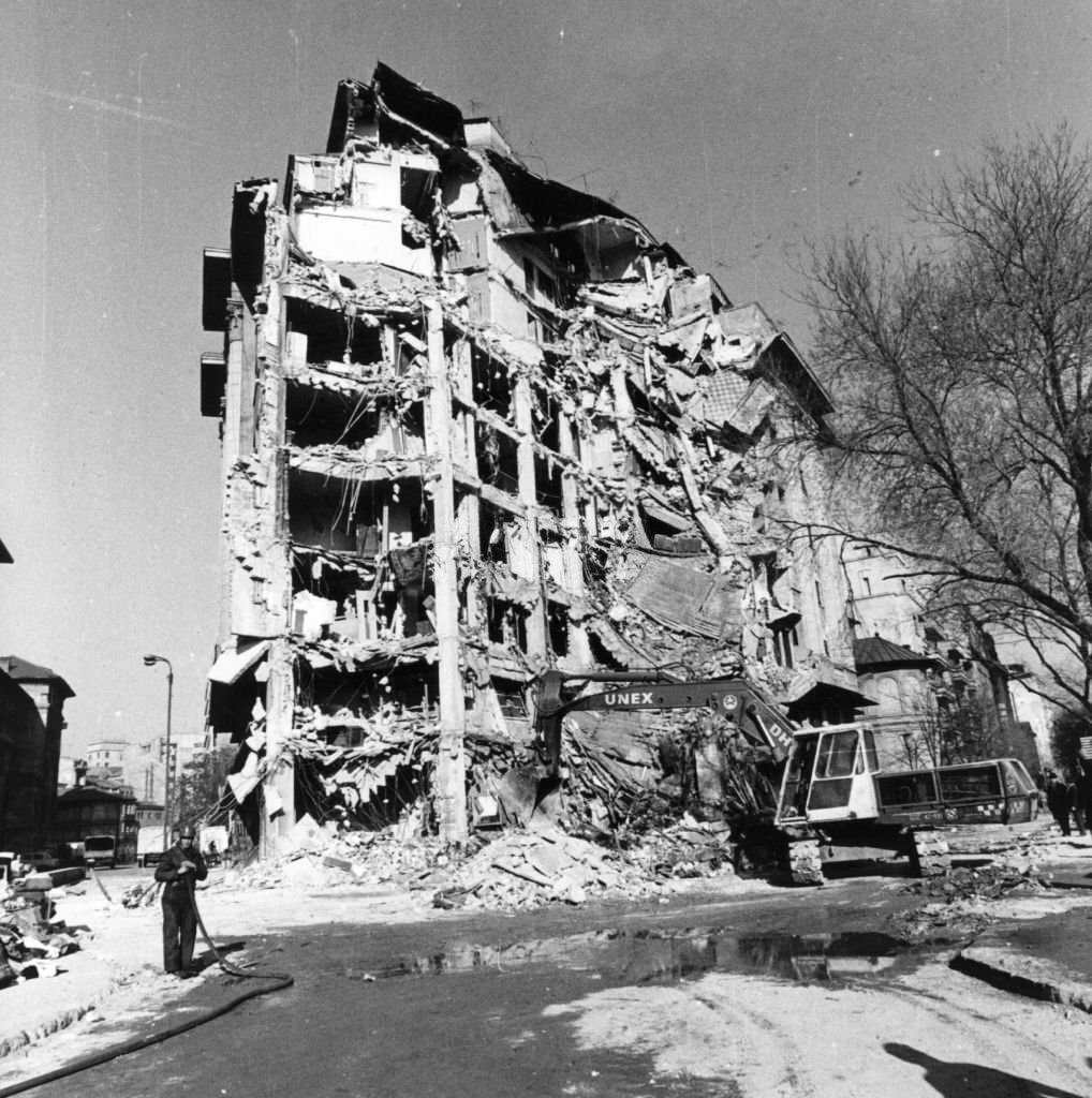 #94 Workmen begin to demolish an earthquake damaged building in University Square, Bucharest, 1977