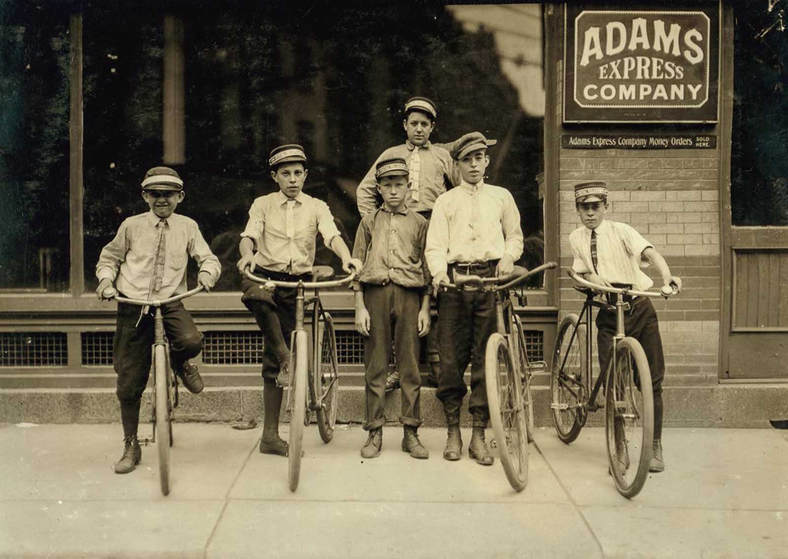 #29 A typical group of Postal Messengers in Norfolk, Va. Smallest on left end, Wilmore Johnson, been there one year. Works days only. The Postal boys are not nearly so young, in Norfolk and also in other Virginia cities, as are the Western Union boys”. June, 1911.