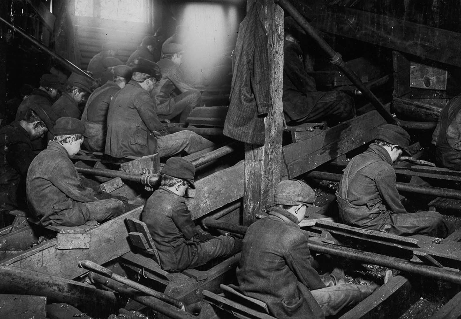 #25 Breaker boys at work breaking coal. The process produces clouds of dust which coat the workers’ lungs, 1911