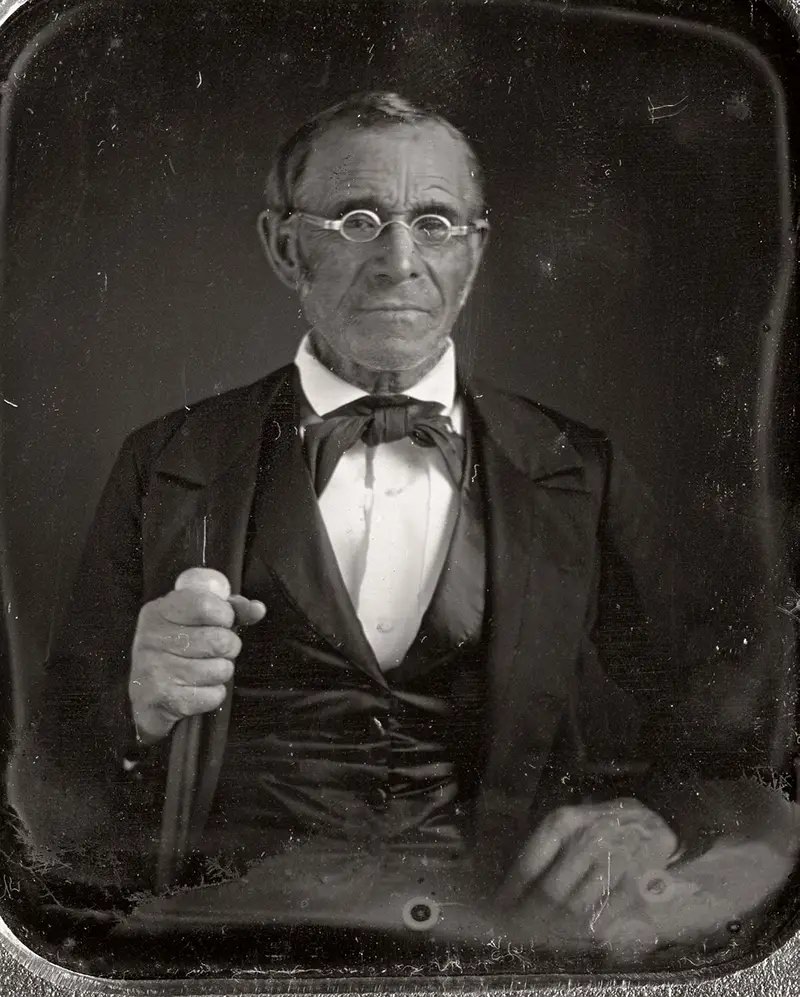 #4 This elderly man is photographed holding a walking cane, 1850.