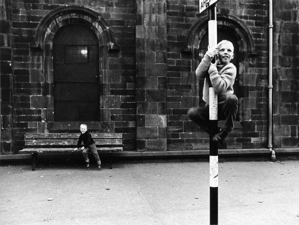#57 Boy climbing the street sign, Stockbridge, Edinburgh, 1965