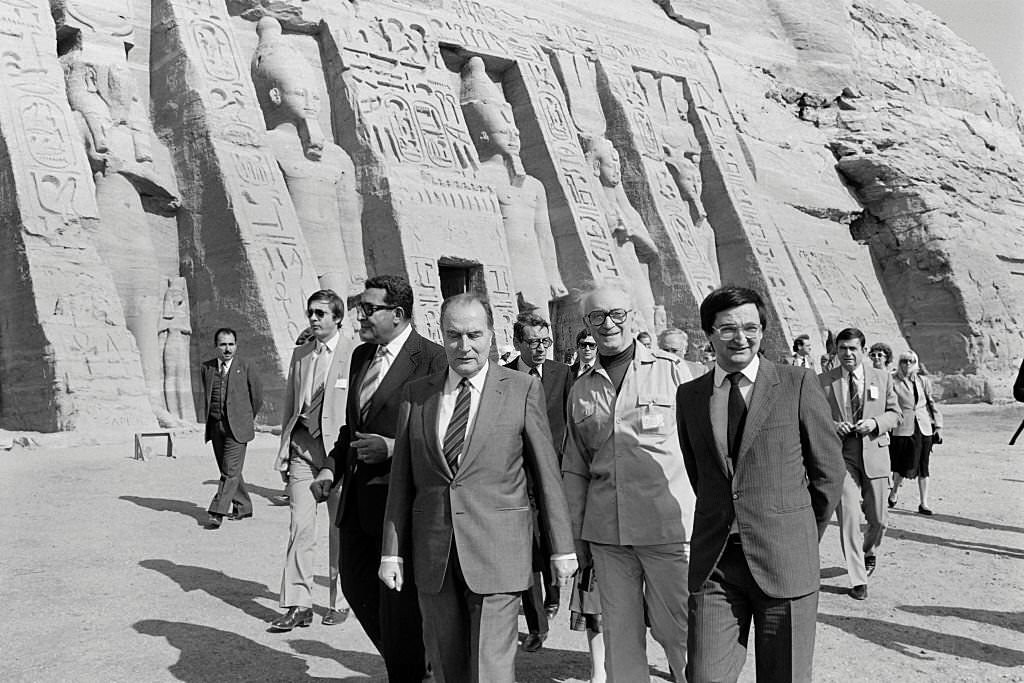#22 French President Francois Mitterrand (C) and his advisor Jacques Attali (R), flanked with their interpreter (2nd R), visit on November 26, 1982 the Abu Simbel temples during an official visit to Egypt.