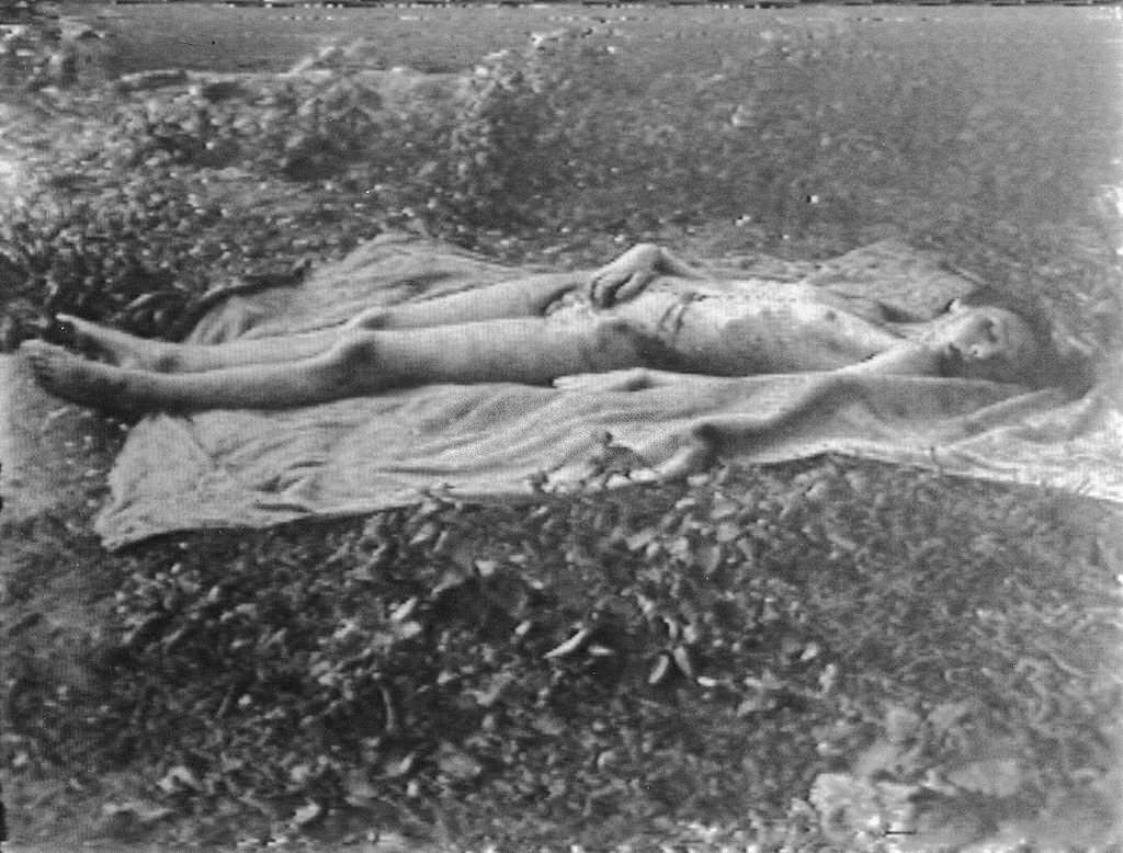 #59 The body of Helga Goebbels lies on a blanket in a field after Russian troops moved her and her siblings’ bodies from the beds in the bunker where their parents poisoned them, Berlin, May 1945
