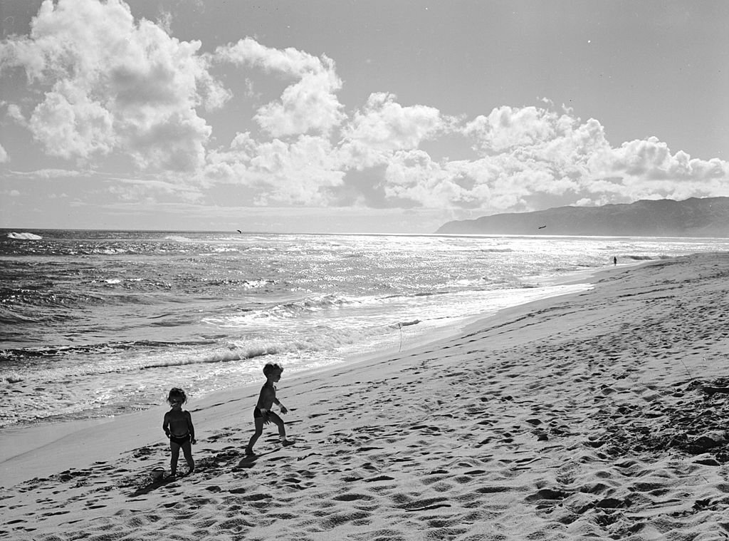 #127 The white sands and warm Pacific waters of a Hawaiian beach, 1955