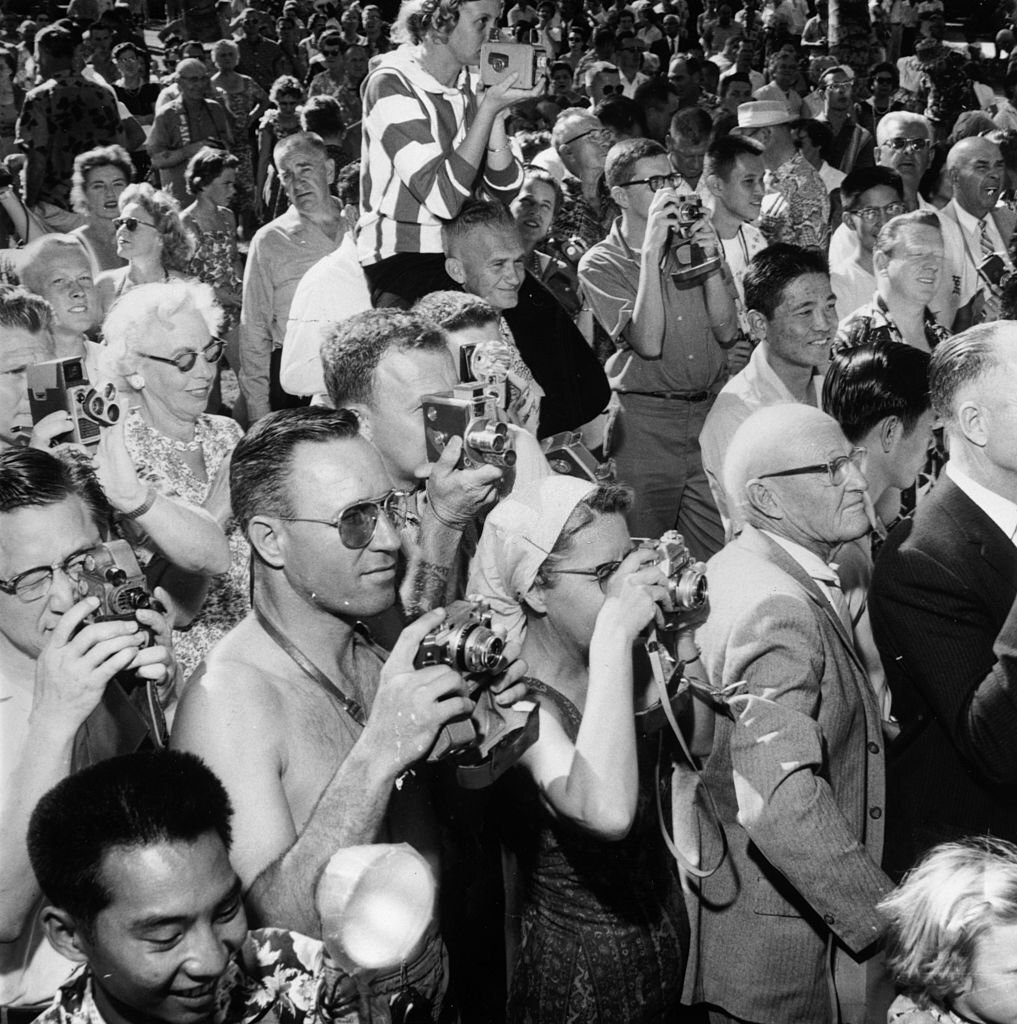#128 A crowd of camera wielding tourists watching a hula show in Honolulu, Hawaii, 1955