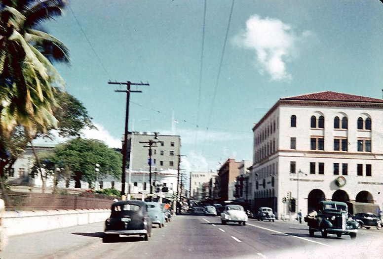 #13 King Street in downtown Honolulu with the wall / fence of Iolani Palace on the left