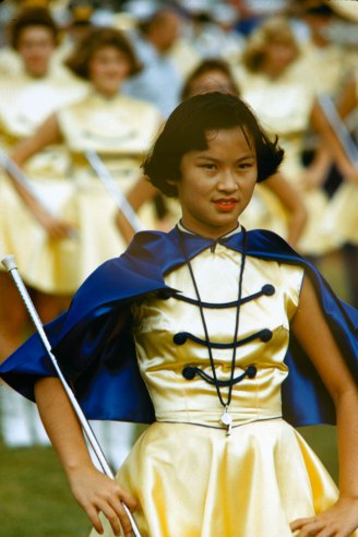 #110 Drum majorette leads band at Honolulu football game, 1959