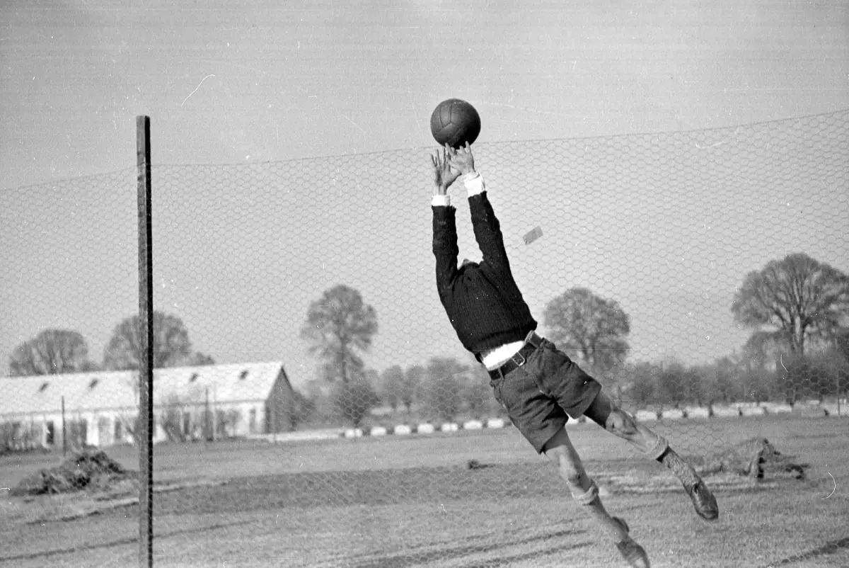 #17 A refugee plays soccer at the Dovercourt holiday camp.