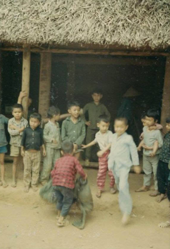 #4 A group of Vietnamese children outside of a hut in an unidentified village in South Vietnam.