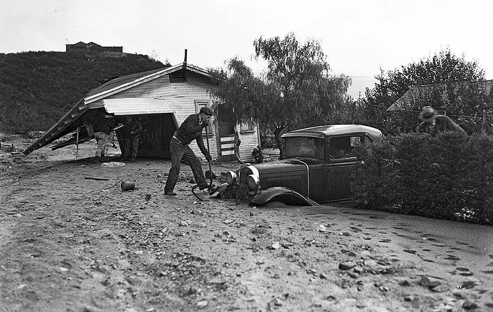 #16 Workers dig out a car and remains of a home on Glenada Avenue in Montrose following flooding from a storm the night before, 1934