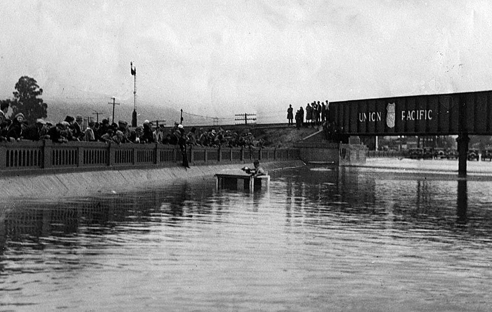 #5 A milk truck is almost completely submerged on Whittier Boulevard under a Union Pacific railroad bridge, 1934