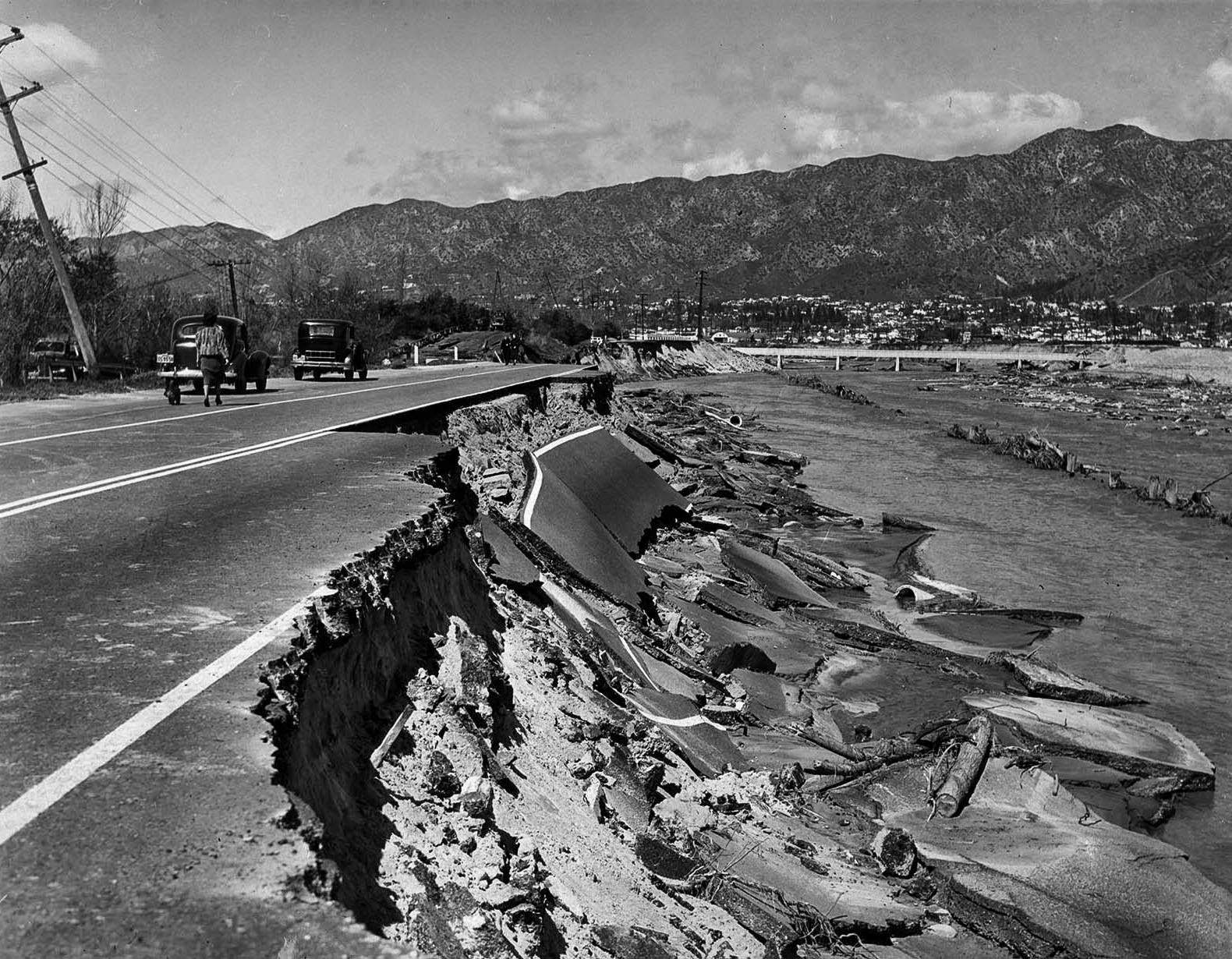 #4 Heavily traveled Riverside Drive in Glendale was undermined by the torrent of the Los Angeles River. This damaged section was near the former Grand Central Airport, 1938