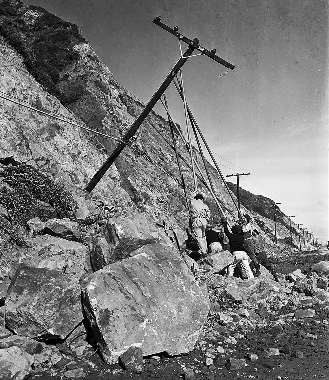 #9 Workers repair a telephone pole. No other information was available, 1938