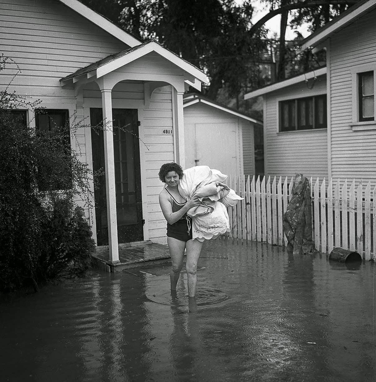 #12 Mrs. L. Swink put on her swimsuit as she moved out after flooding, 1938