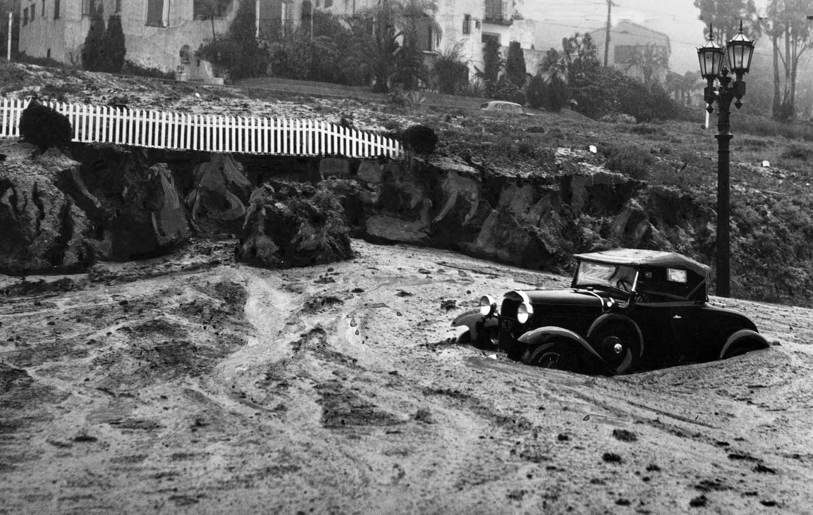 #20 A mudslide at Harper Avenue and Sunset Boulevard caught this automobile and closed the area to traffic, 1938