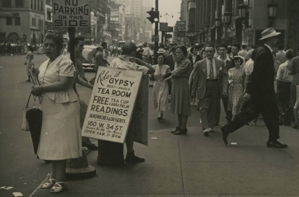 #3 A man wears a sandwich board sign for Gypsy Tea Room on a busy street in Midtown Manhattan, 1950