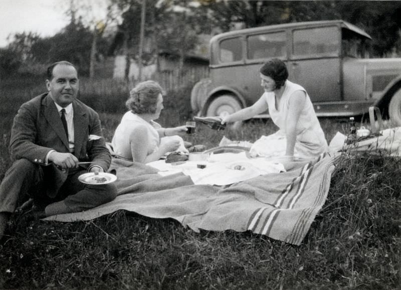 #1 A company of three enjoying a picnic in the countryside, 1931