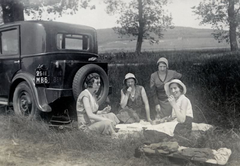 #3 Four fashionable ladies enjoying a picnic in the countryside next to a Peugeot 201, registered in the French département of Nord, 1932