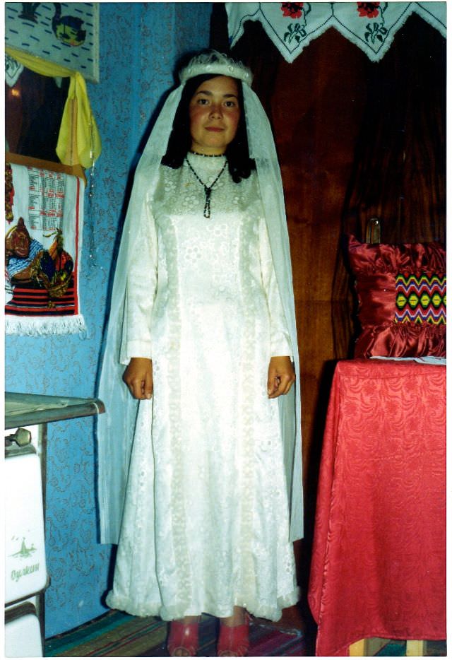 #31 Gülizar trying on a wedding gown, Polyanovo, Bulgaria, 1976