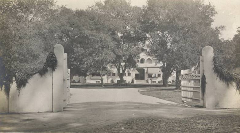 #99 Front of large estate with gate, possibly one of Sarah Winchester homes, 1922