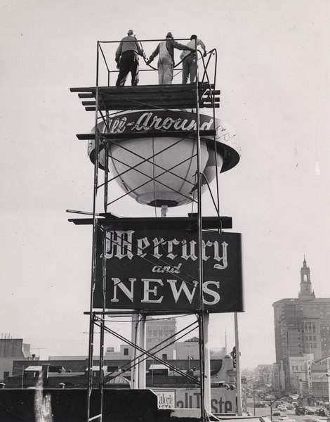 #20 Three men on top of the Mercury and News tower looking down on First Street, San Jose, 1965